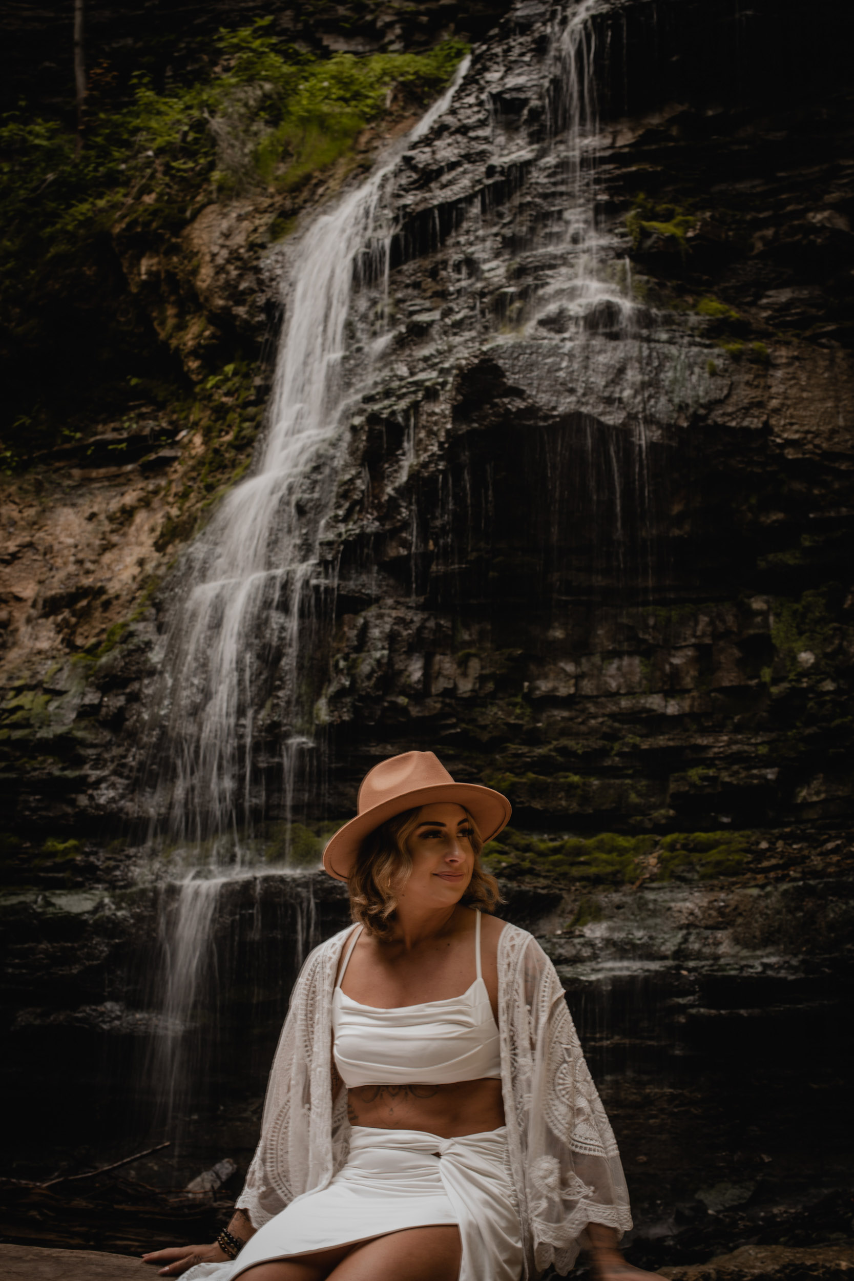 woman in front of waterfall
