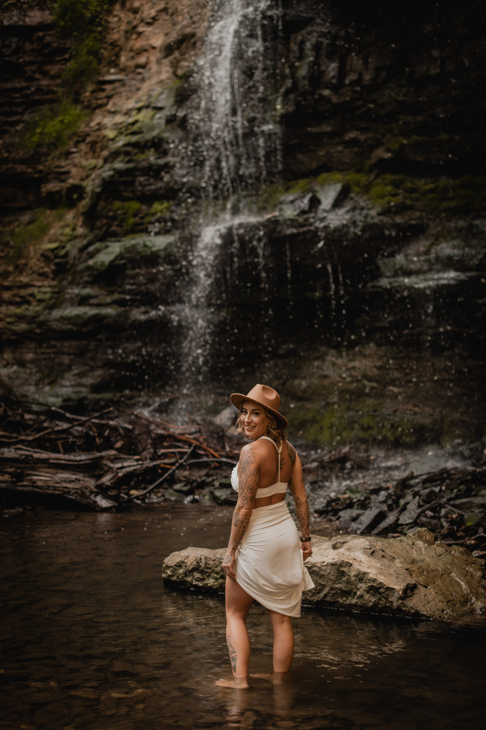 woman in front of waterfall