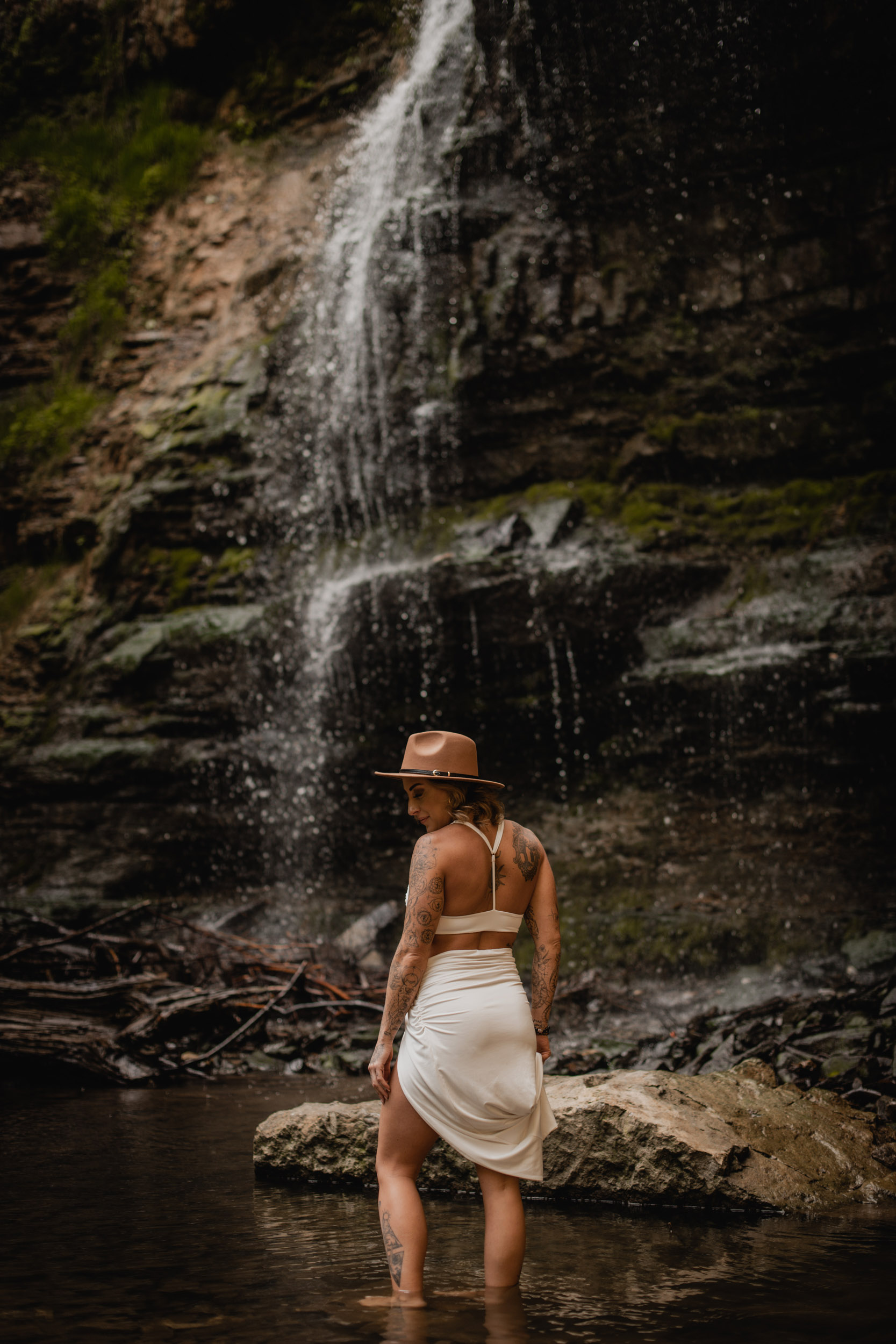 woman in front of waterfall