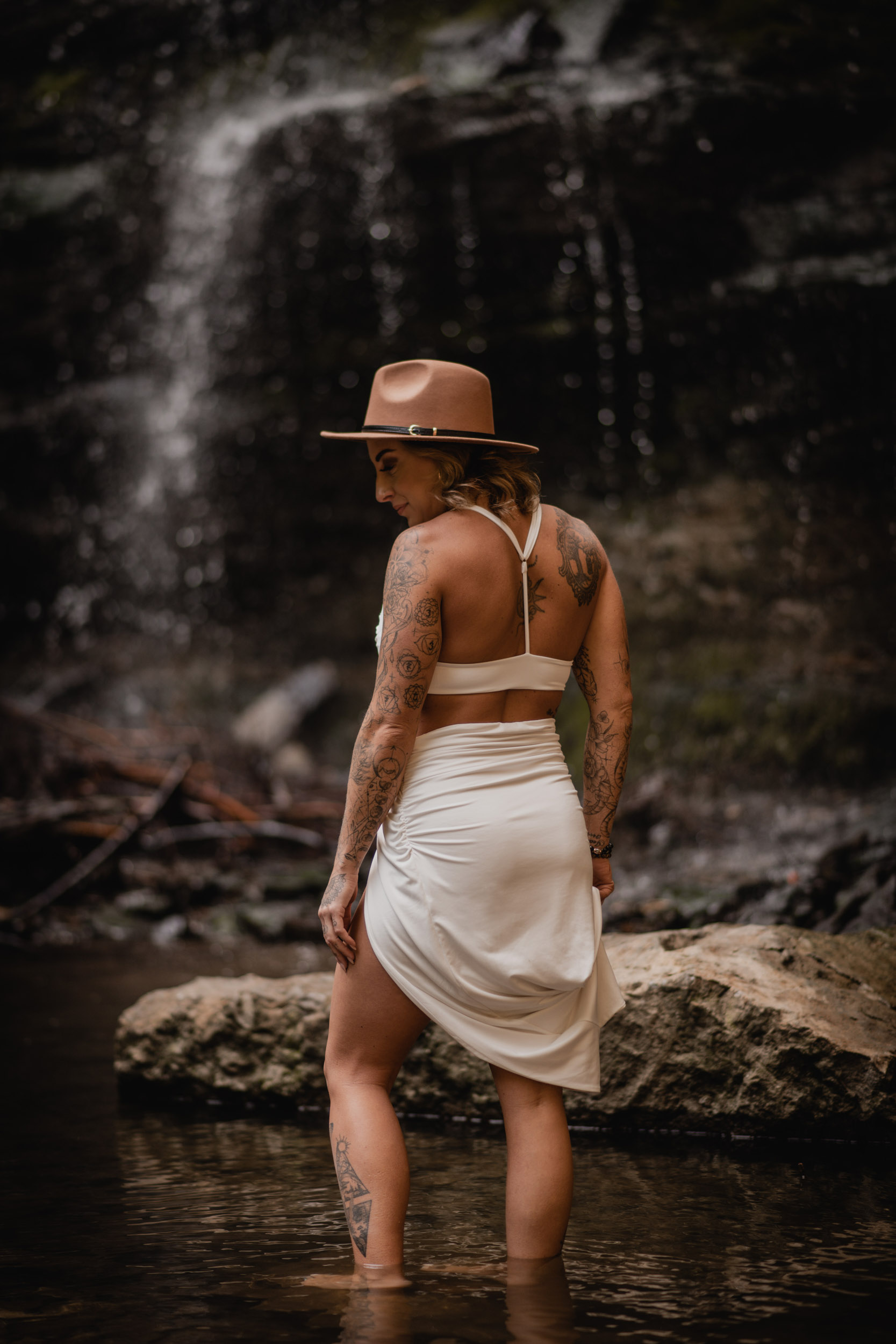 woman in front of waterfall