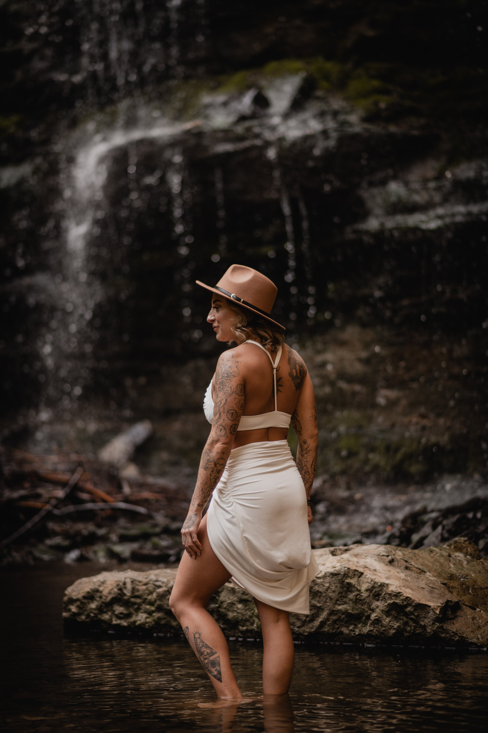 woman in front of waterfall